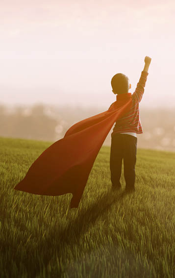 boy dreaming of being superhero  looking at the city